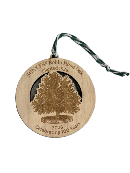 A round wooden commemorative ornament featuring an engraved robin hood oak tree and the text 'SUNY ESF Robin Hood Oak Planted 1926' and '2026 Celebrating 100 Years.' A twisted green-and-white string is attached at the top.