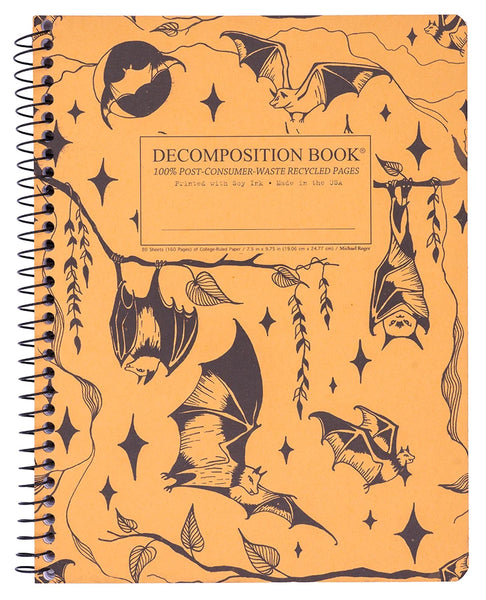 A spiral-bound composition notebook with a yellow-orange cover featuring black bat illustrations and the text 'DECOMPOSITION BOOK' on the front.