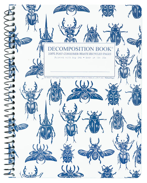 Side spiral notebook with blue beetles illustrations on a white background. Written in the center, Decomposition Book. 100% Post-Consumer-Waste Recycled Pages. Printed with Soy Ink. Made in the USA