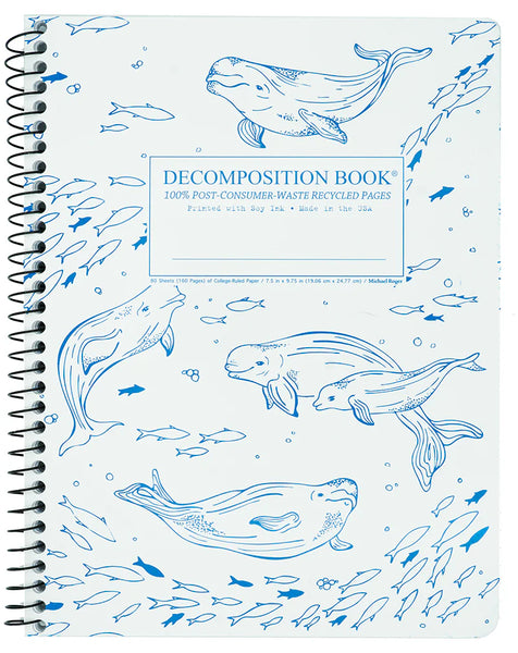A side spiral-bound notebook with a white cover decorated with blue line drawings of belugas. The center label reads 'DECOMPOSITION BOOK' with smaller text below. 100% Post-Consumer-Waste Recycled Pages. Printed with Soy Ink. Made in the USA. 