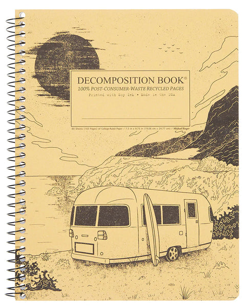 A side spiral-bound decomposition book with a tan cover with a big sur with a camper and a surf board. A tan rectangular label on the front reads 'DECOMPOSITION BOOK' with smaller text below. 100% Post-Consumer-Waster Recycled Pages. Printed with Soy Ink. Made in the USA