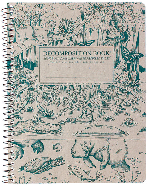 A spiral-bound decomposition book with a beige cover printed in teal-green illustrations of everglades animals and plants, including a manatee, alligator, turtle, puma, and monarch butterflies. The front cover reads 'DECOMPOSITION BOOK' and '100% POST-CONSUMER WASTE RECYCLED PAGES. Printed with Soy Ink. Made in the USA.