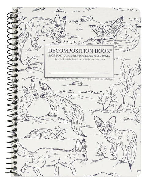 A spiral-bound decomposition book with black-and-white fennec fox illustrations and a central label reading 'DECOMPOSITION BOOK' and '100% POST-CONSUMER-WASTE RECYCLED PAGES.'. Printed with Soy Ink. Made in the USA