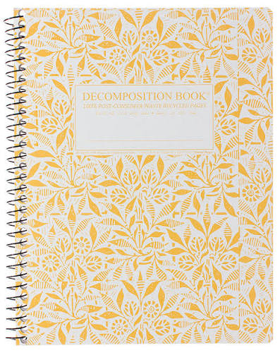 A spiral-bound decomposition book with a white cover decorated in a yellow botanical leaf pattern. The center features a white label with gold text that reads 'DECOMPOSITION BOOK'.