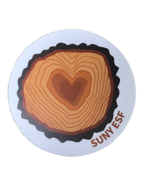 A round magnet with an image of a heart-shaped cross-section of a tree. Underneath the tree is SUNY ESF