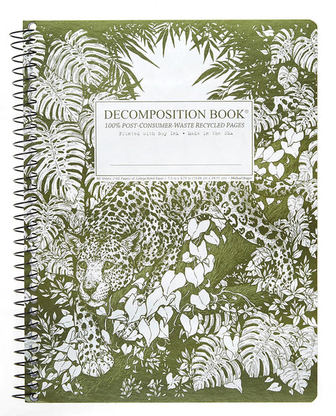 A spiral-bound decomposition book with a green and white tropical floral and Jaguar print cover, featuring a white label in the center that reads 'DECOMPOSITION BOOK 100% POST-CONSUMER-WASTE RECYCLED PAGES'. Printed with Soy Ink. Made in the USA