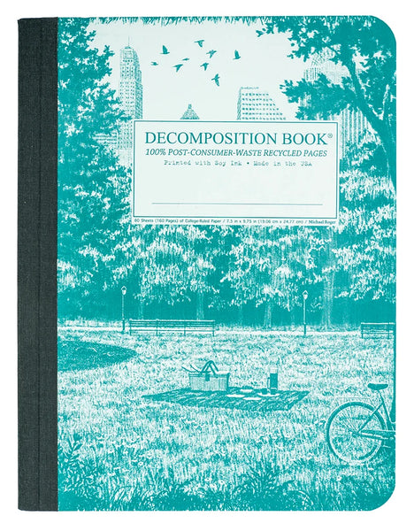 A decomposition book with a dark gray cloth-bound spine and a turquoise cover featuring a park illustration and a white product label in the center. Decomposition Bool. 100% Post-Consumer-Waste Recycled Pages. Printed with Soy Ink. Made in the USA.
